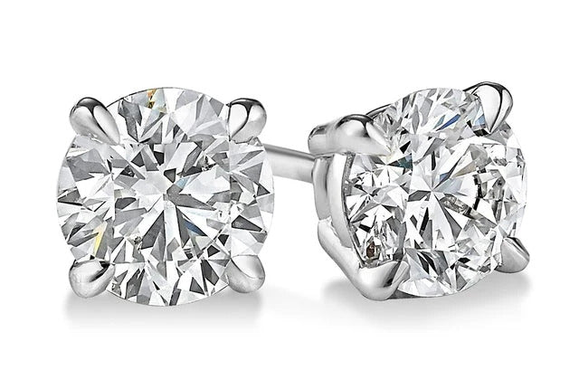 Pair of diamond stud earrings on a white background